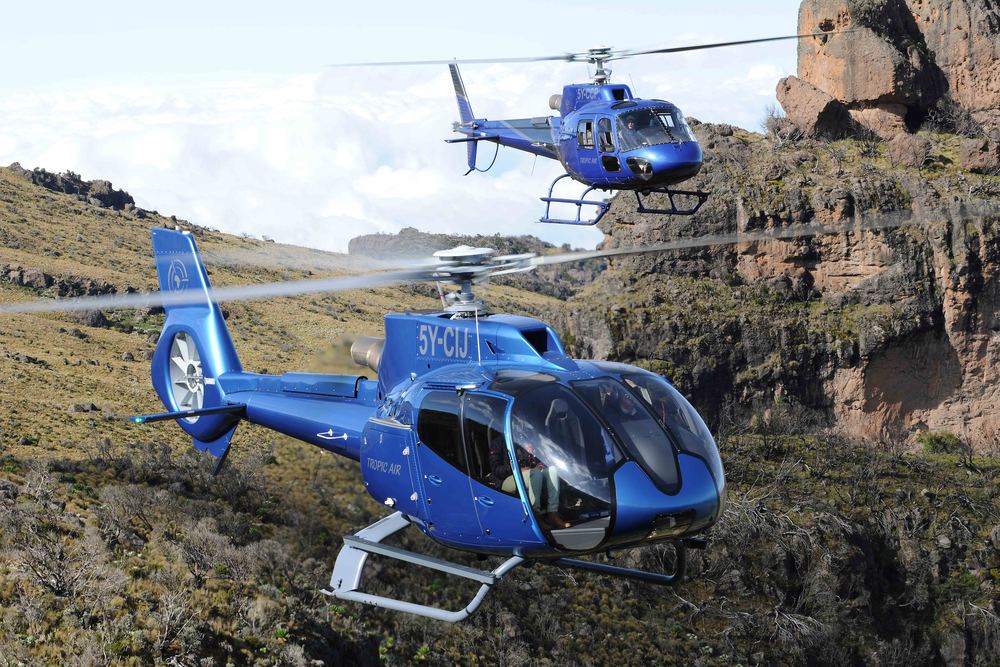 Tropic Air helicopter in flight over Kenya's highlands en route to the Masai Mara